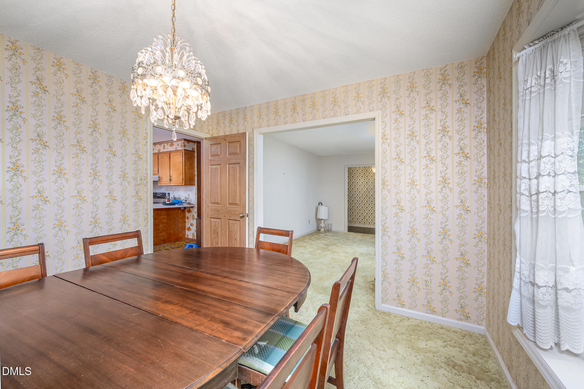 4411 Rhew Drive Durham, NC 27704 - Photo 11 of 34 a view of a dining room with furniture and chandelier