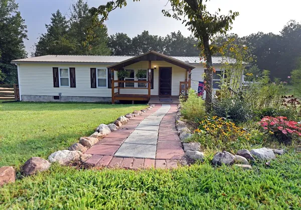 a front view of a house with garden