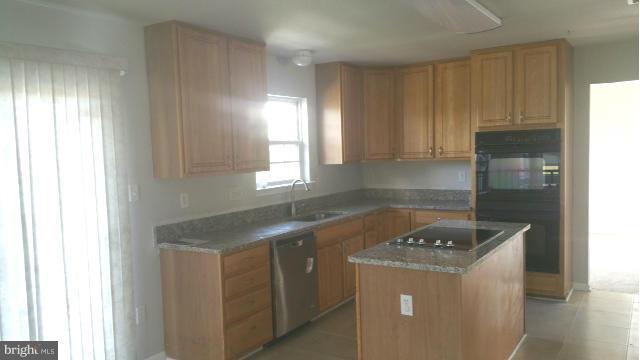 3004 Kidder Road Clinton, MD 20735 - Photo 6 of 23 a kitchen with a stove a sink and a window