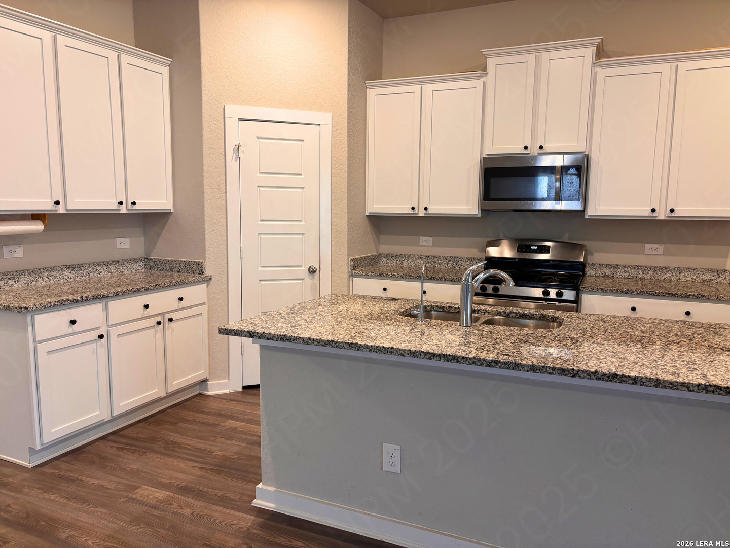 10754 Francisco Way Converse, TX 78109 - Photo 12 of 18 a kitchen with granite countertop a sink a stove and cabinets