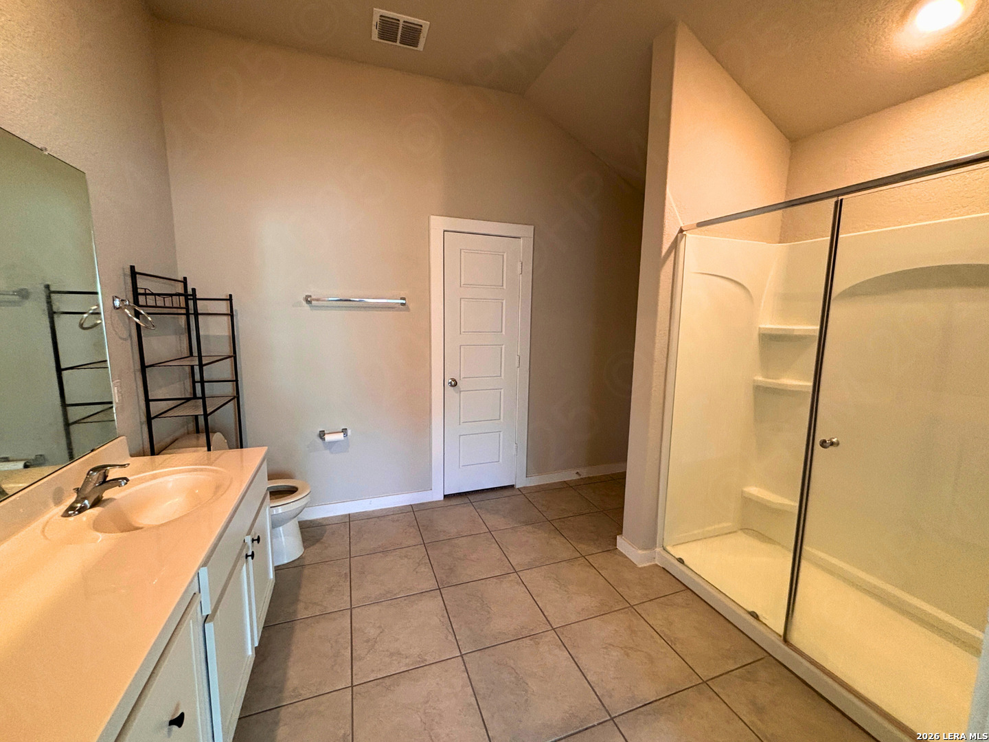 10754 Francisco Way Converse, TX 78109 - Photo 15 of 18 a bathroom with a granite countertop sink a mirror and shower