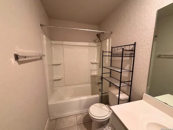an empty room with closet and fan
