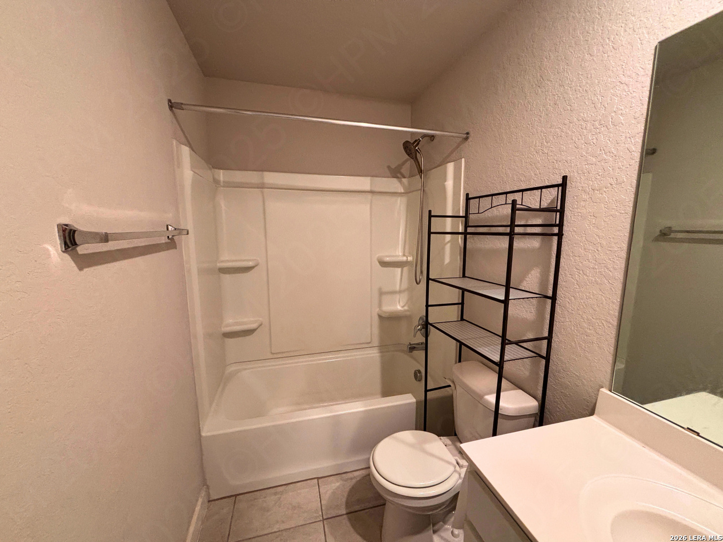 10754 Francisco Way Converse, TX 78109 - Photo 5 of 18 a bathroom with a toilet a sink and shower