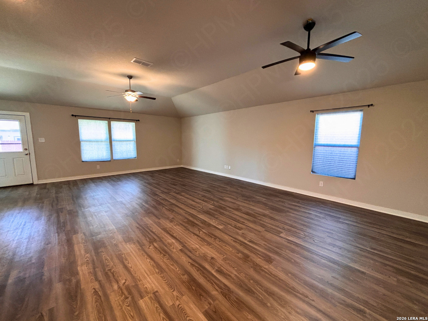 10754 Francisco Way Converse, TX 78109 - Photo 10 of 18 a view of an empty room with wooden floor and a window