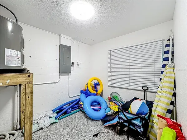 a kitchen with stainless steel appliances granite countertop a stove a sink a microwave a refrigerator and cabinets