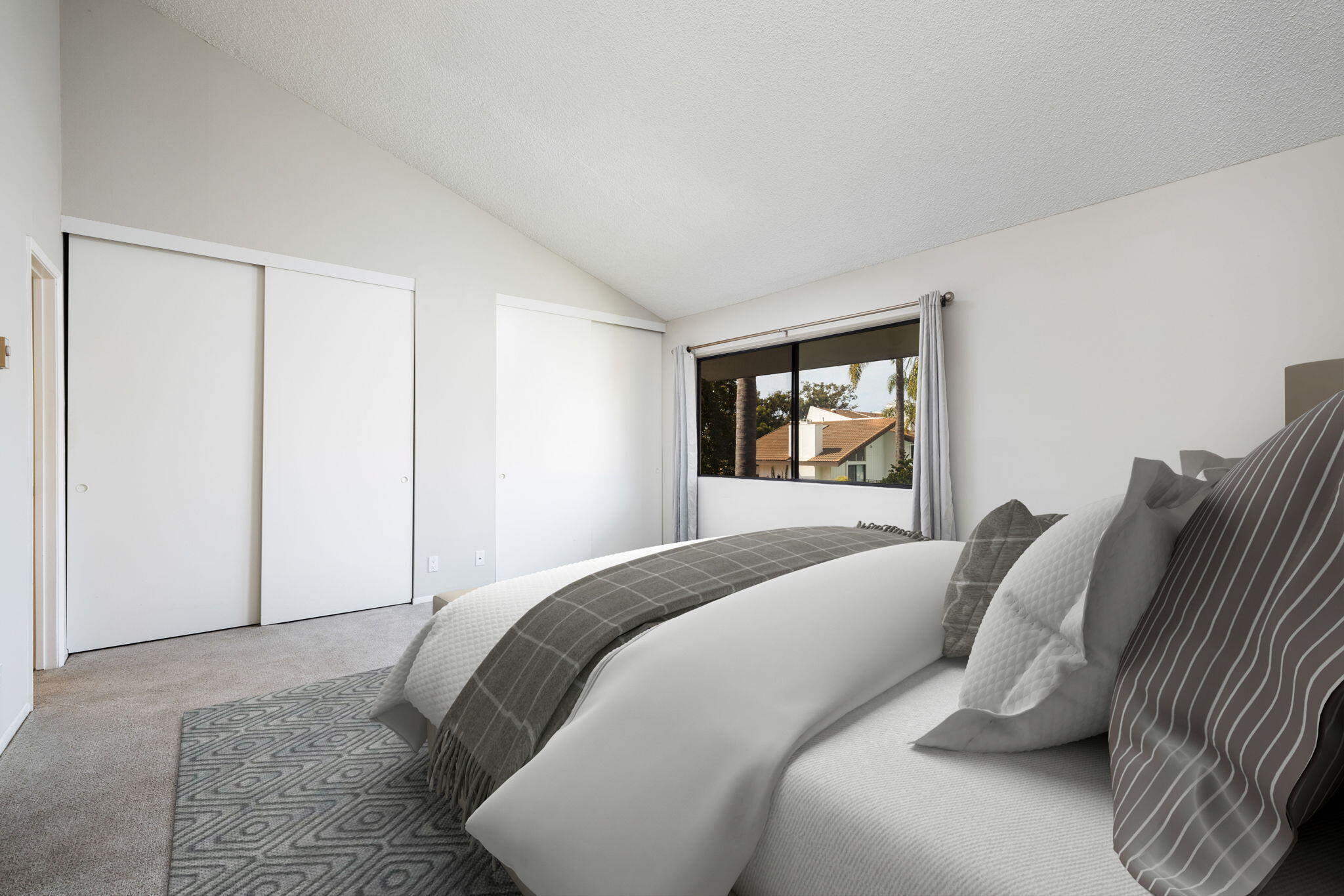 653 Verde Mar Drive, Unit E Santa Barbara, CA 93103 - Photo 14 of 23 a bedroom with a bed and a large window