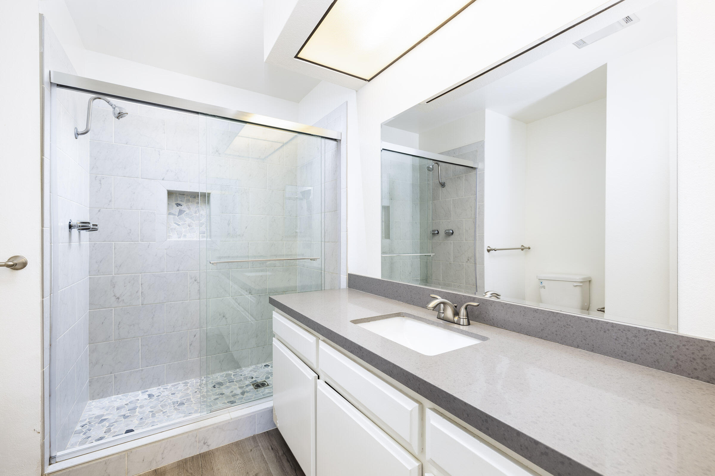 653 Verde Mar Drive, Unit E Santa Barbara, CA 93103 - Photo 15 of 23 a bathroom with a granite countertop shower sink and mirror