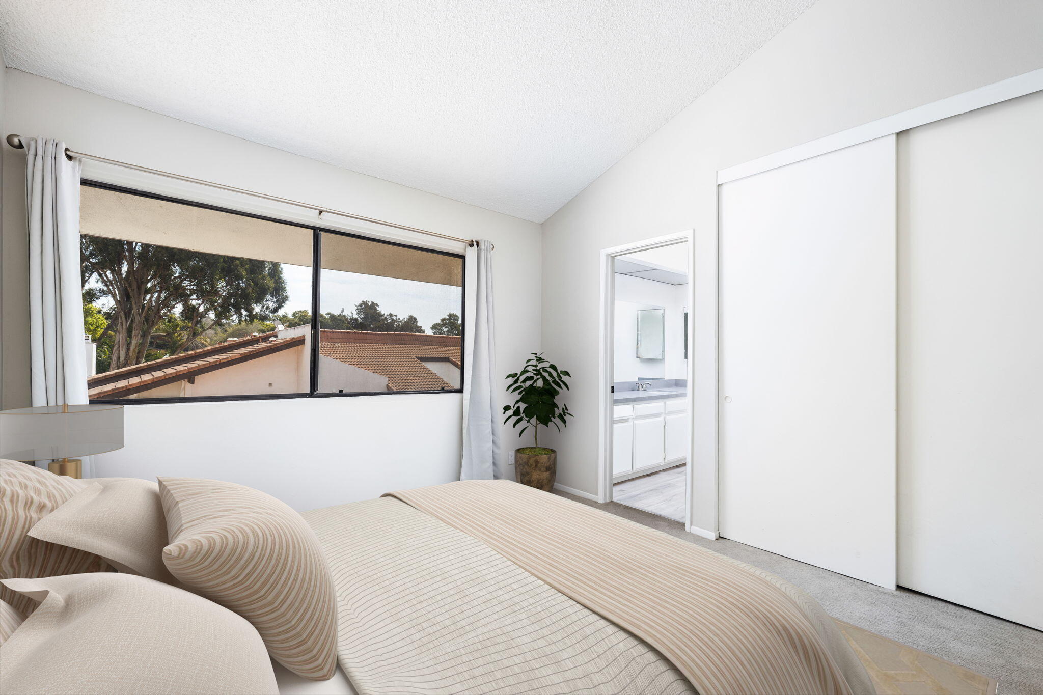 653 Verde Mar Drive, Unit E Santa Barbara, CA 93103 - Photo 17 of 23 a bedroom with a bed and a painting on the wall
