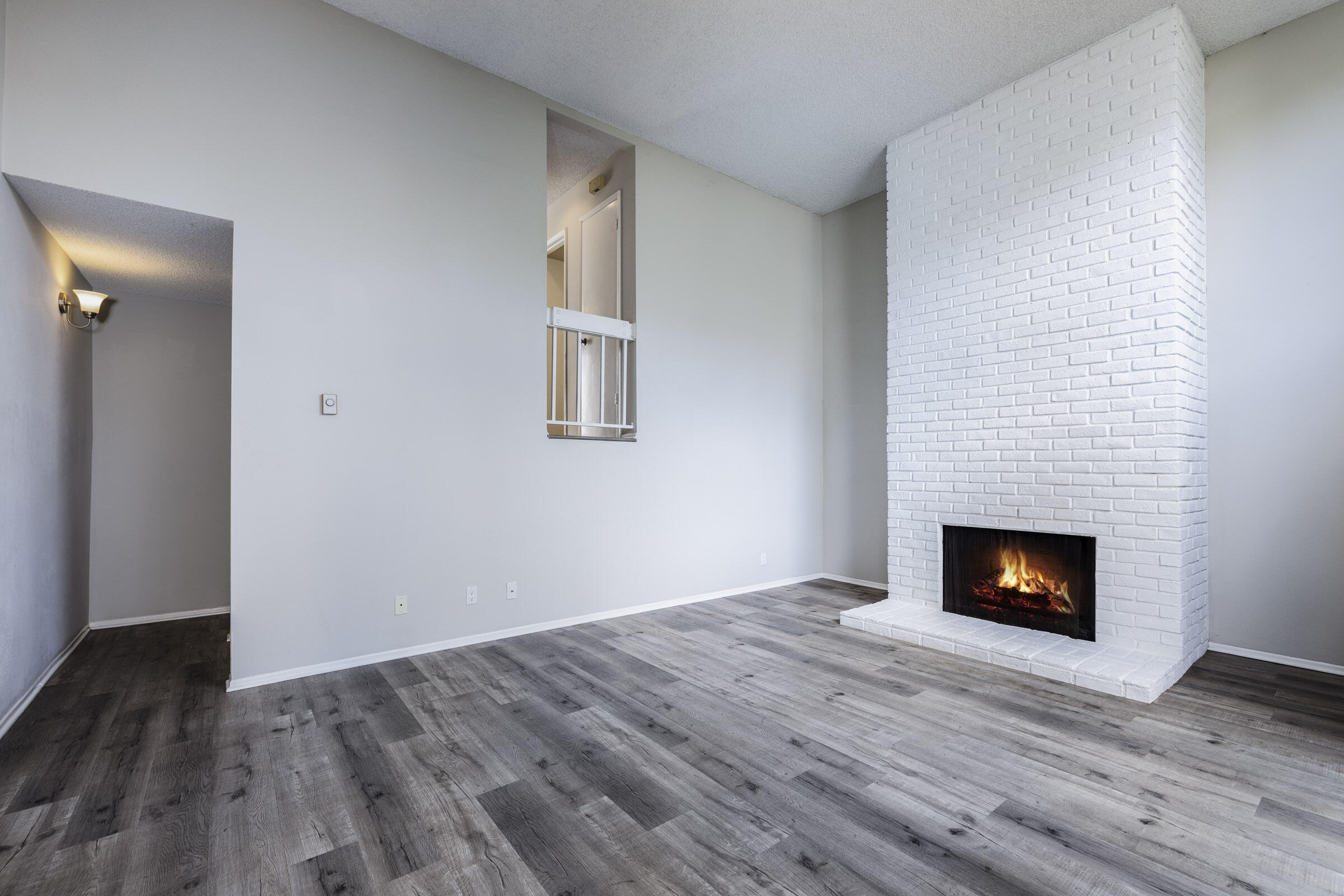 653 Verde Mar Drive, Unit E Santa Barbara, CA 93103 - Photo 7 of 23 a view of a livingroom with wooden floor and a fireplace