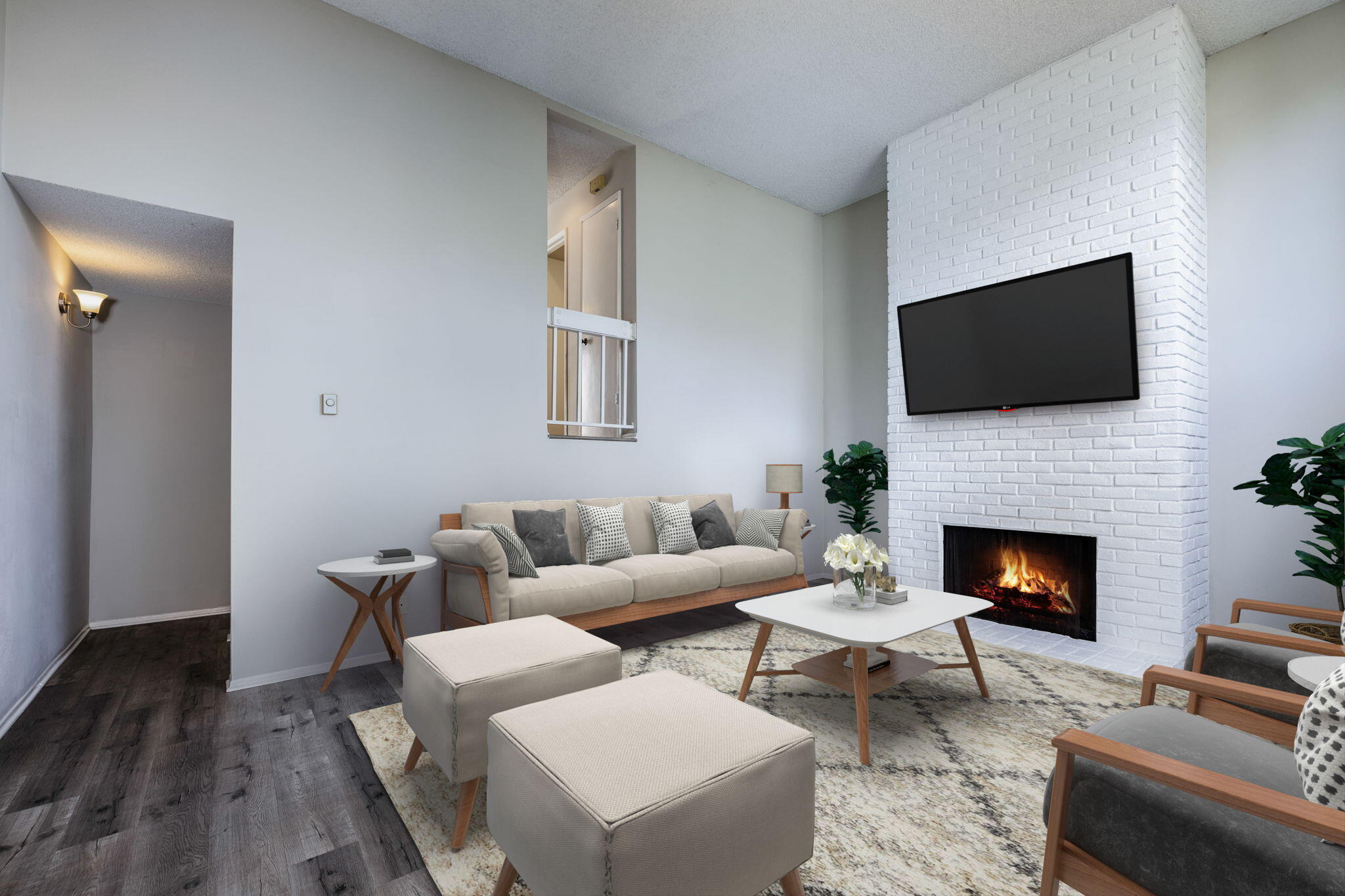 653 Verde Mar Drive, Unit E Santa Barbara, CA 93103 - Photo 8 of 23 a living room with furniture a fireplace and a flat screen tv