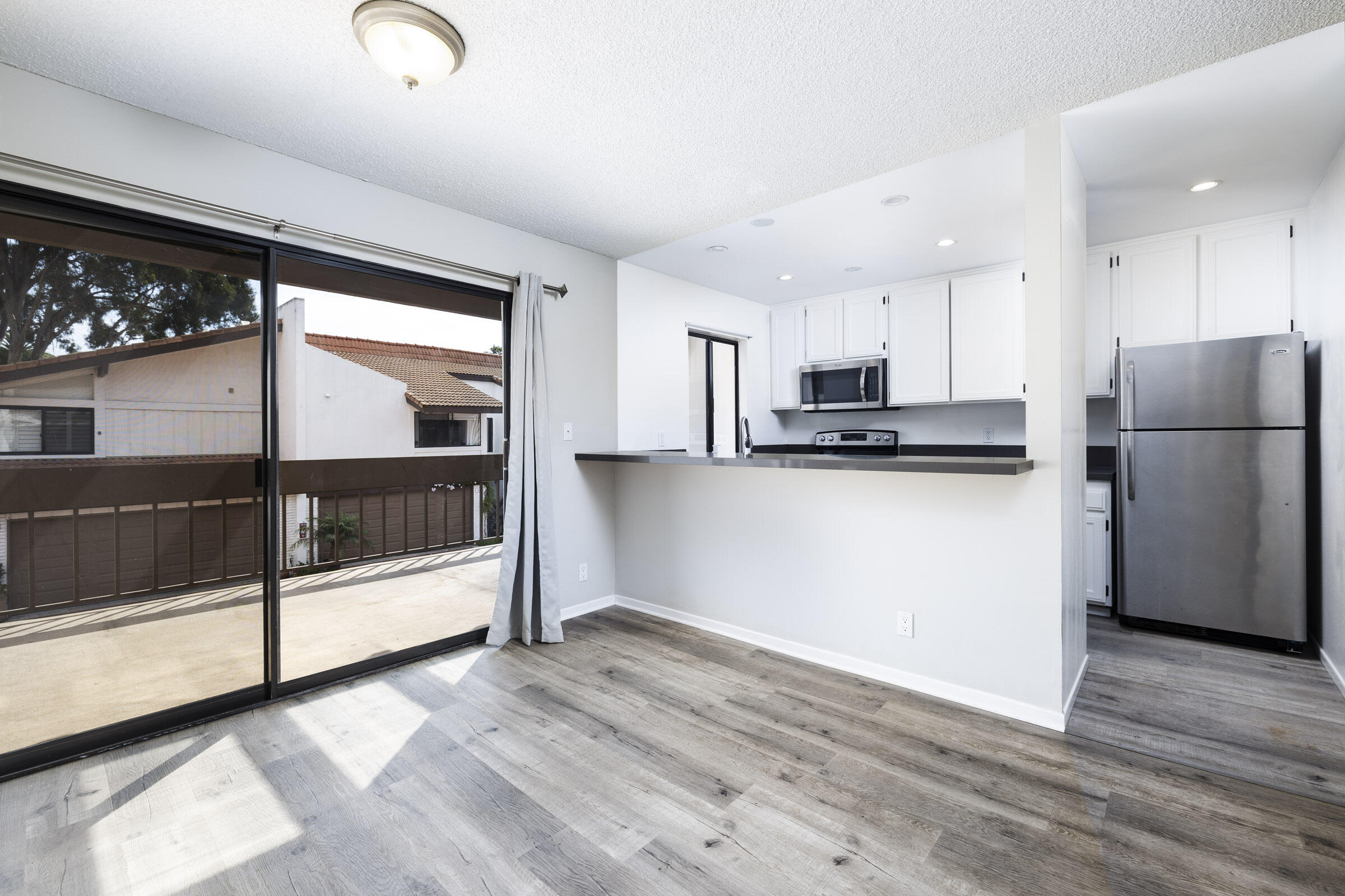 653 Verde Mar Drive, Unit E Santa Barbara, CA 93103 - Photo 9 of 23 a kitchen with stainless steel appliances a refrigerator and a stove top oven
