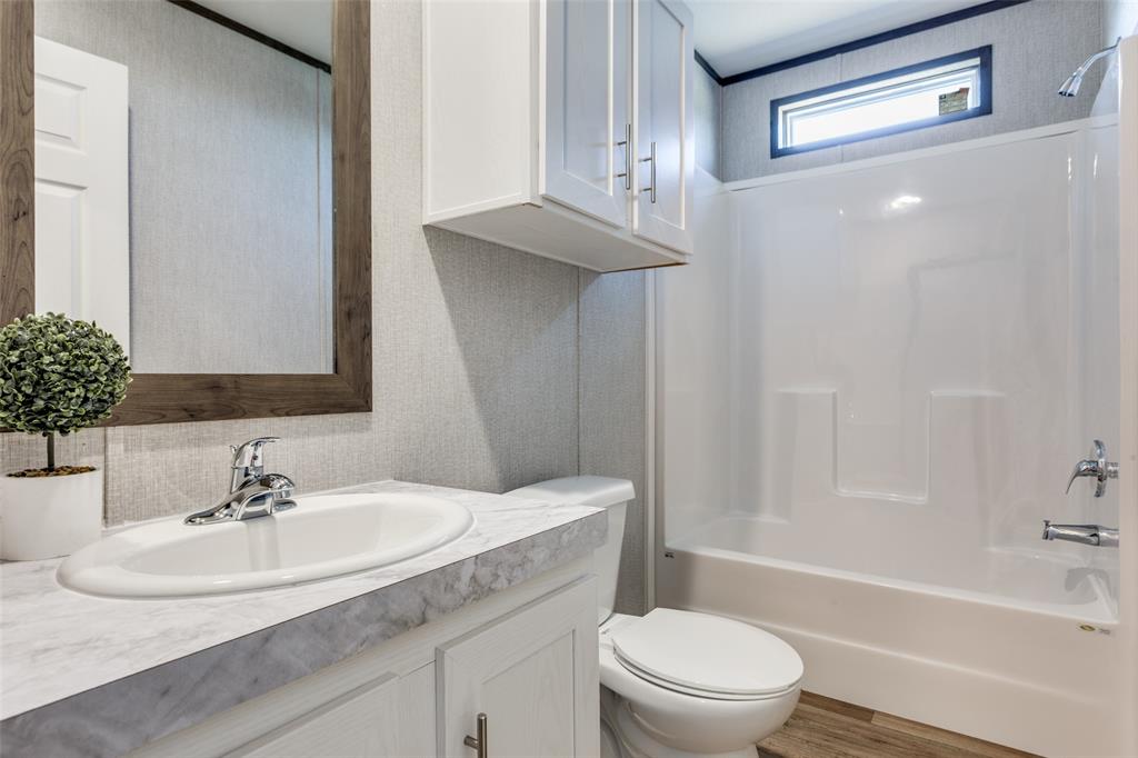 175 Cedar Drive Azle, TX 76020 - Photo 23 of 25 a bathroom with a sink a toilet and a bathtub