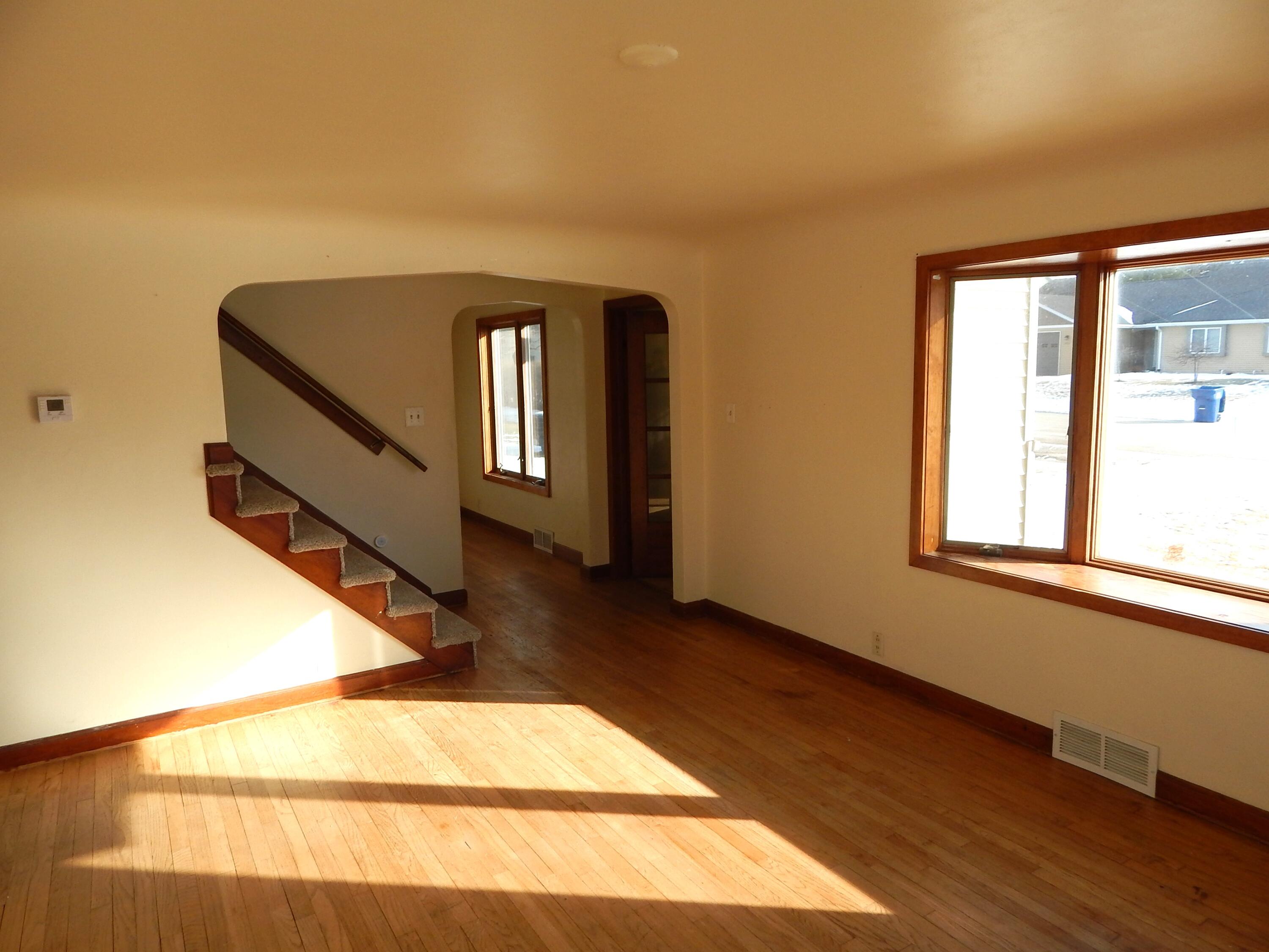 4040 Spring Court Sheboygan, WI 53081 - Photo 6 of 16 LIving Room looking at open staircase and entrance to DR