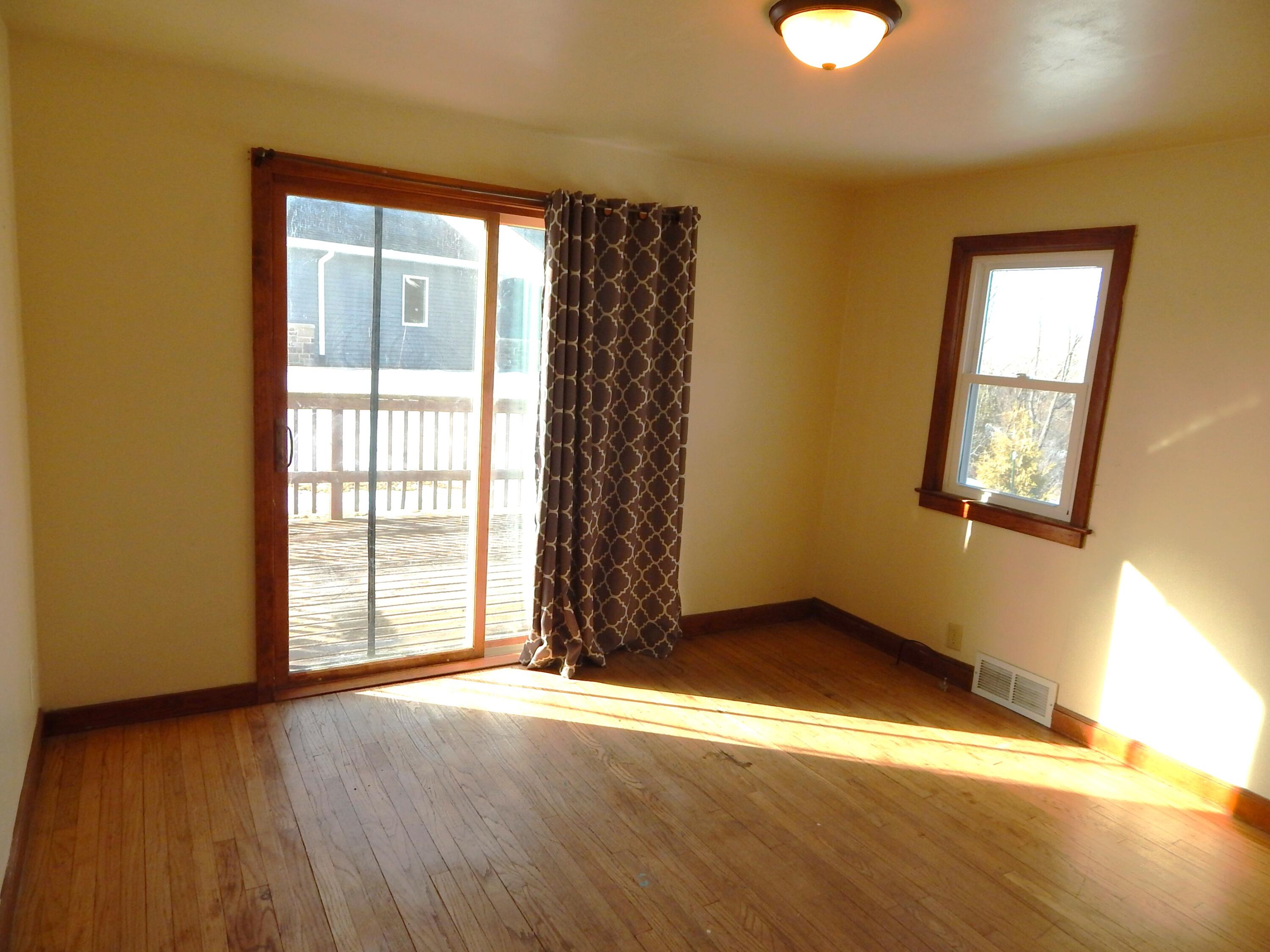 4040 Spring Court Sheboygan, WI 53081 - Photo 10 of 16 Den with patio door to western facing deck