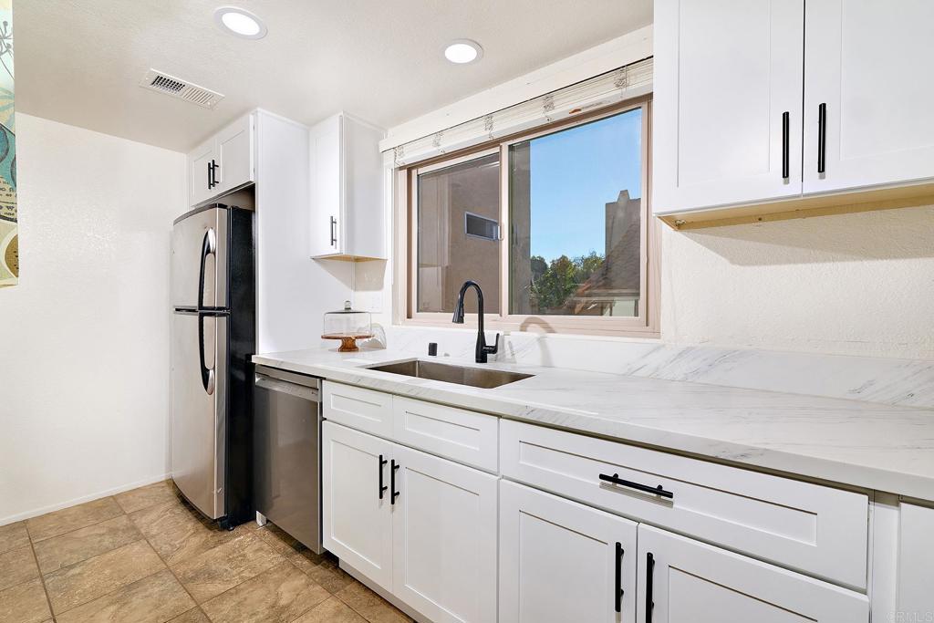 1055 Ficus Lane San Marcos, CA 92069 - Photo 7 of 16 a kitchen with a sink and refrigerator