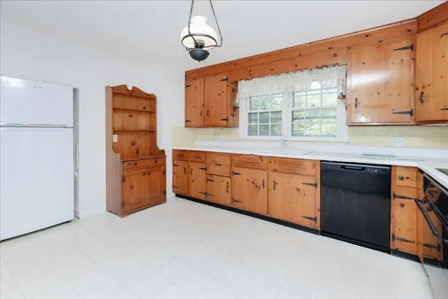 a kitchen with stainless steel appliances granite countertop a sink a stove and a refrigerator