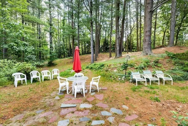 a chair and table sitting in backyard of a house