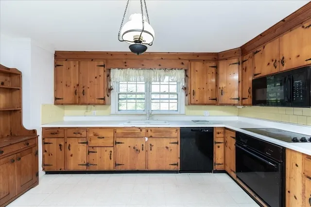 a kitchen with stainless steel appliances granite countertop a sink and dishwasher a stove top oven with wooden floor