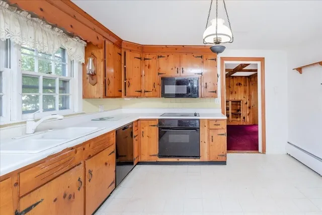 a kitchen with stainless steel appliances granite countertop a sink a stove and a refrigerator