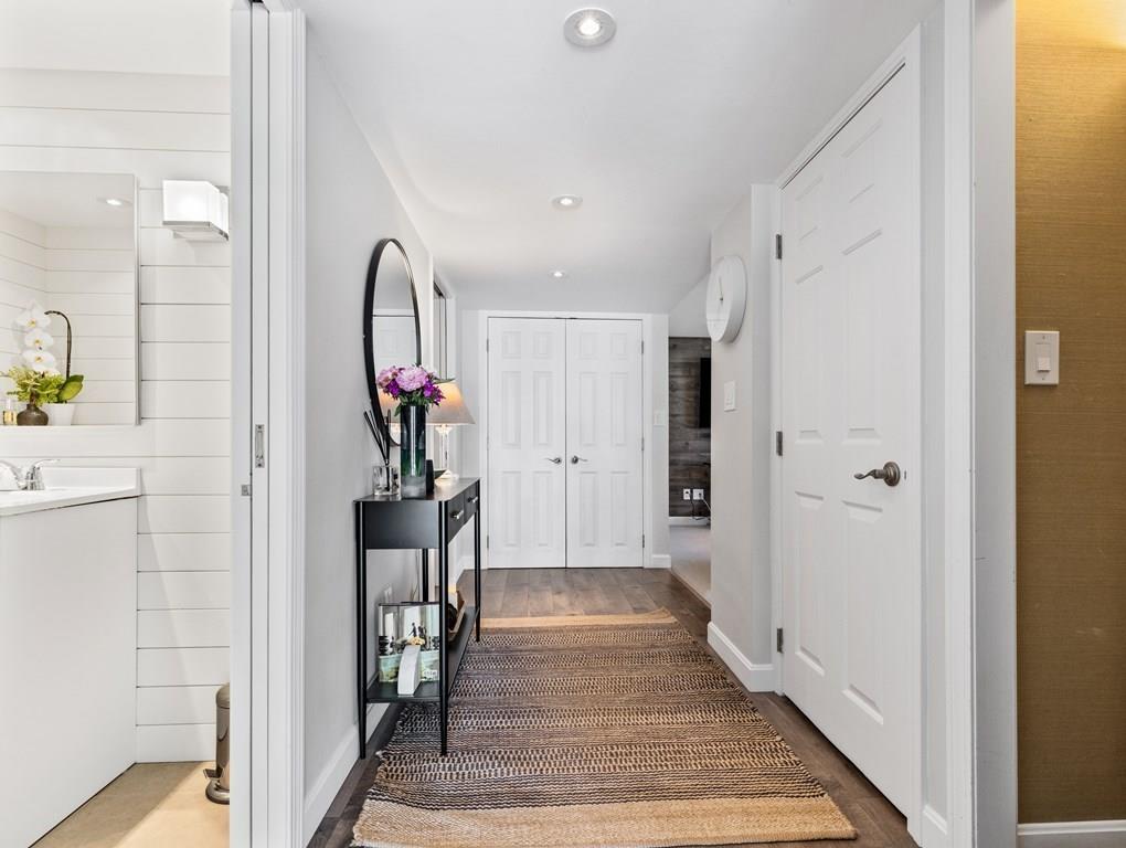 78 Standish Road Needham, MA 02492 - Photo 11 of 16 a view of a hallway to a livingroom and dining room with wooden floor