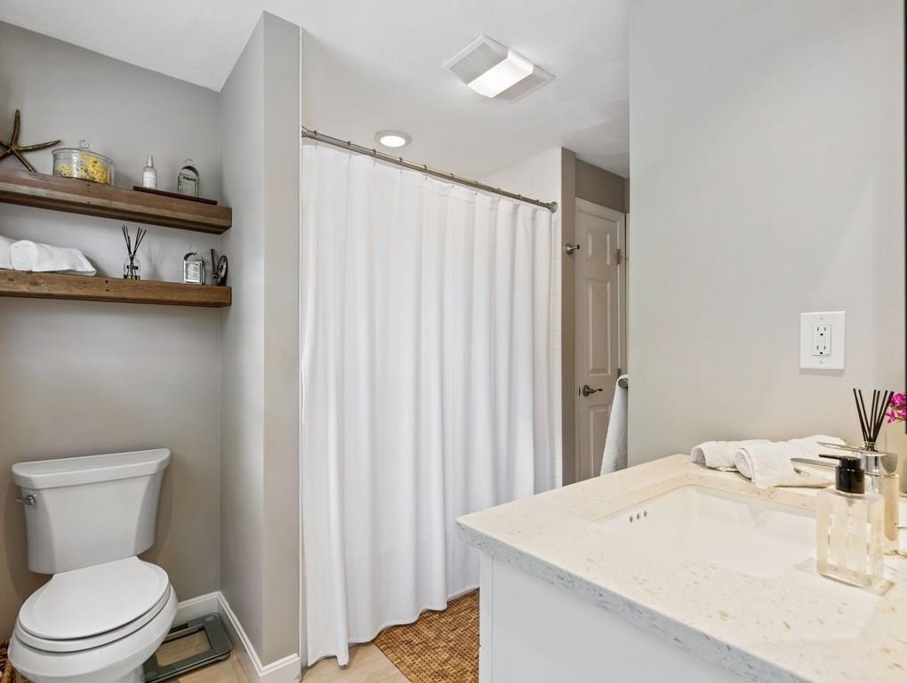 78 Standish Road Needham, MA 02492 - Photo 8 of 16 a white toilet sitting next to a bathroom sink