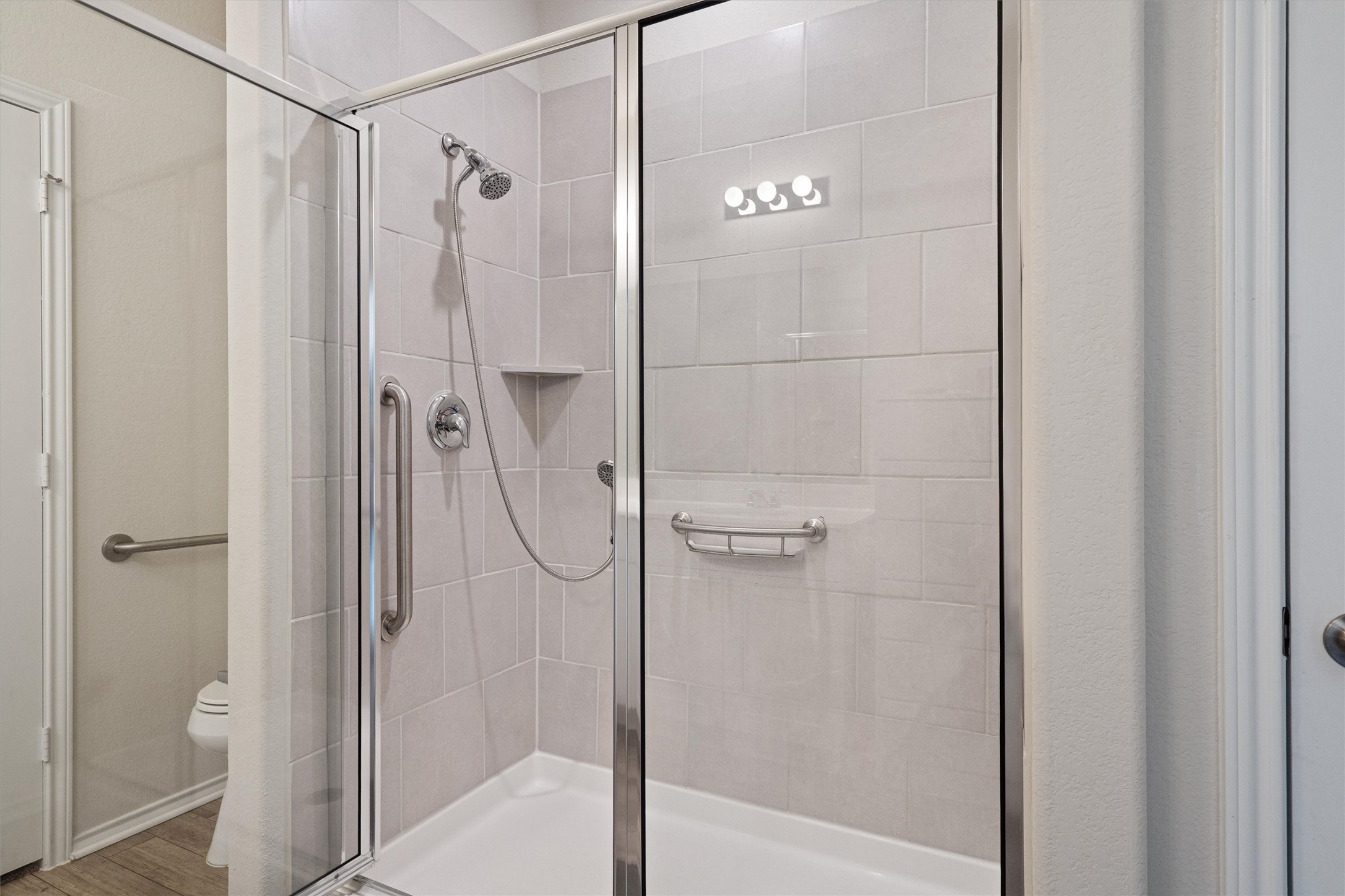 160 Gunther Way Taylor, TX 76574 - Photo 13 of 24 a bathroom with a glass shower door