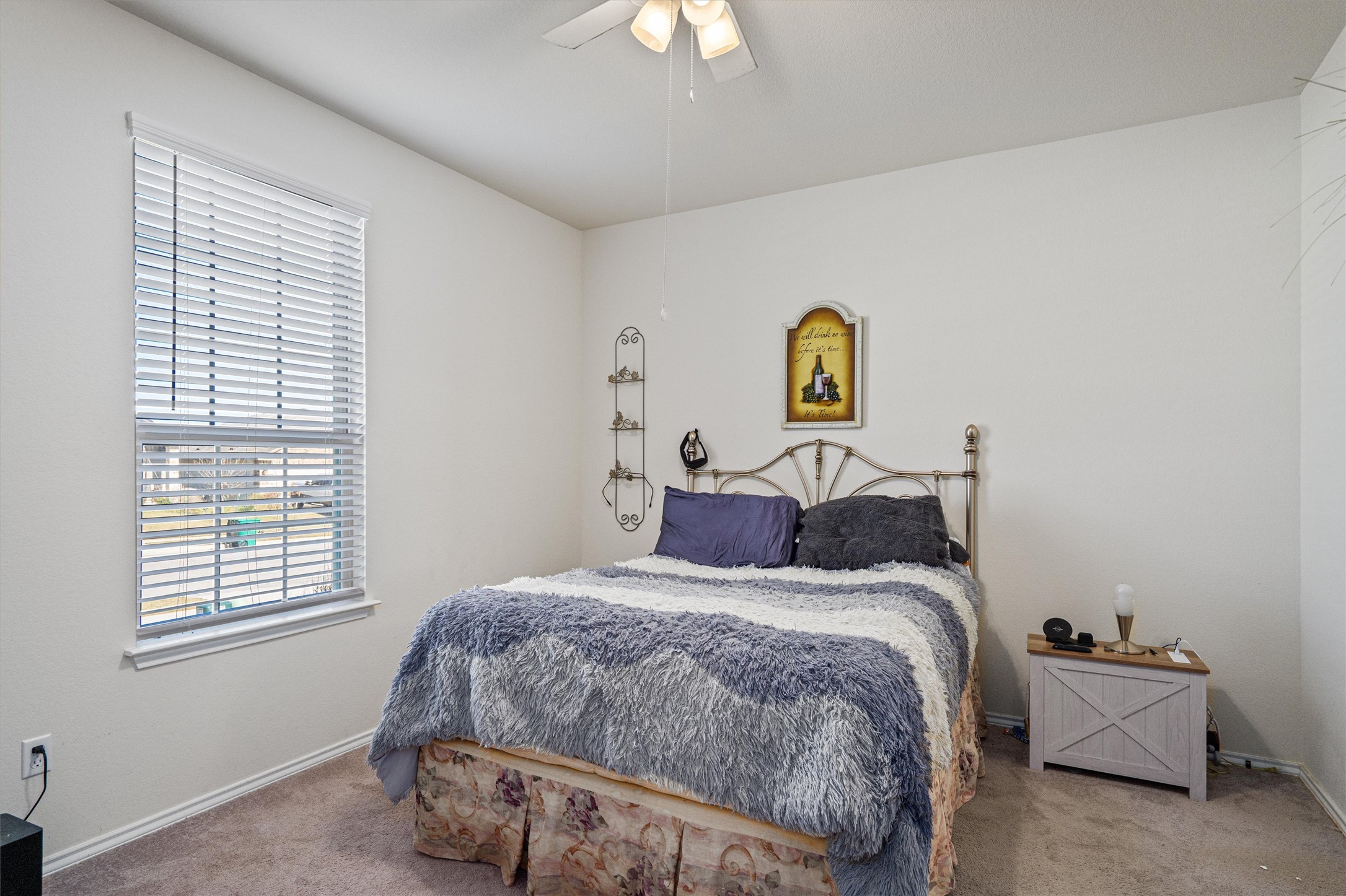 160 Gunther Way Taylor, TX 76574 - Photo 14 of 24 a bedroom with a bed and a chandelier
