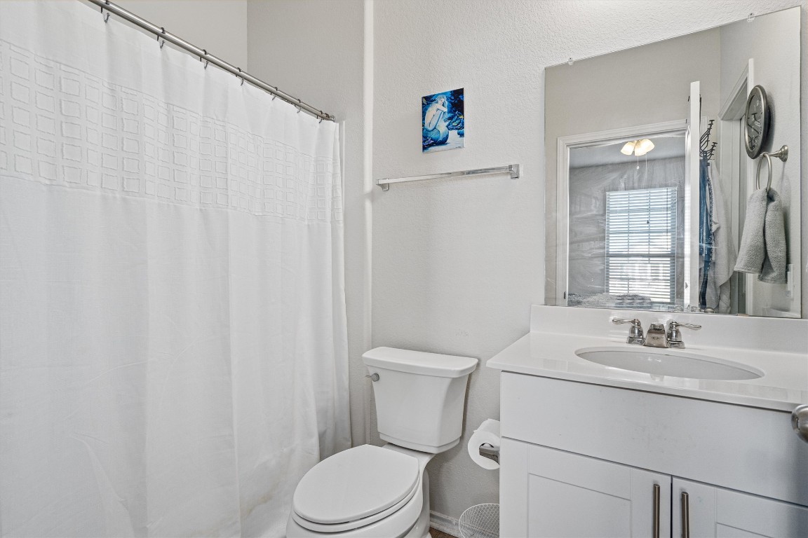 160 Gunther Way Taylor, TX 76574 - Photo 16 of 24 a bathroom with a sink a toilet and shower curtain