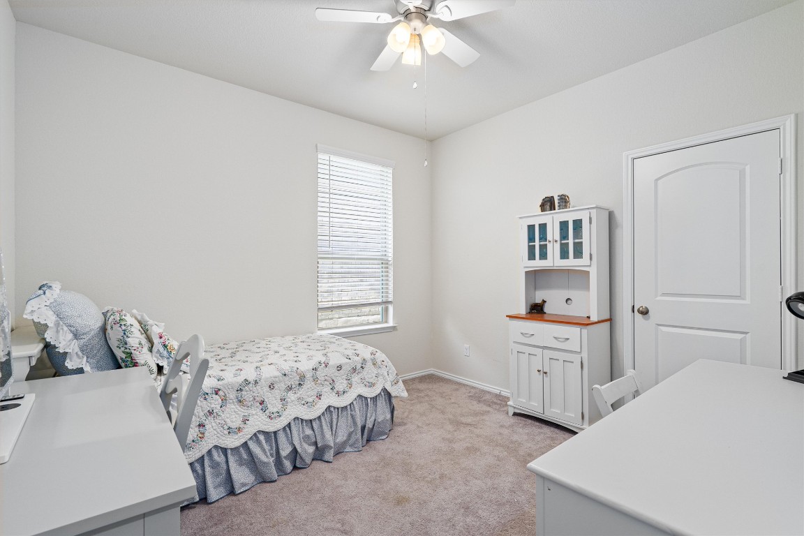 160 Gunther Way Taylor, TX 76574 - Photo 17 of 24 a bedroom with a bed and a cabinets