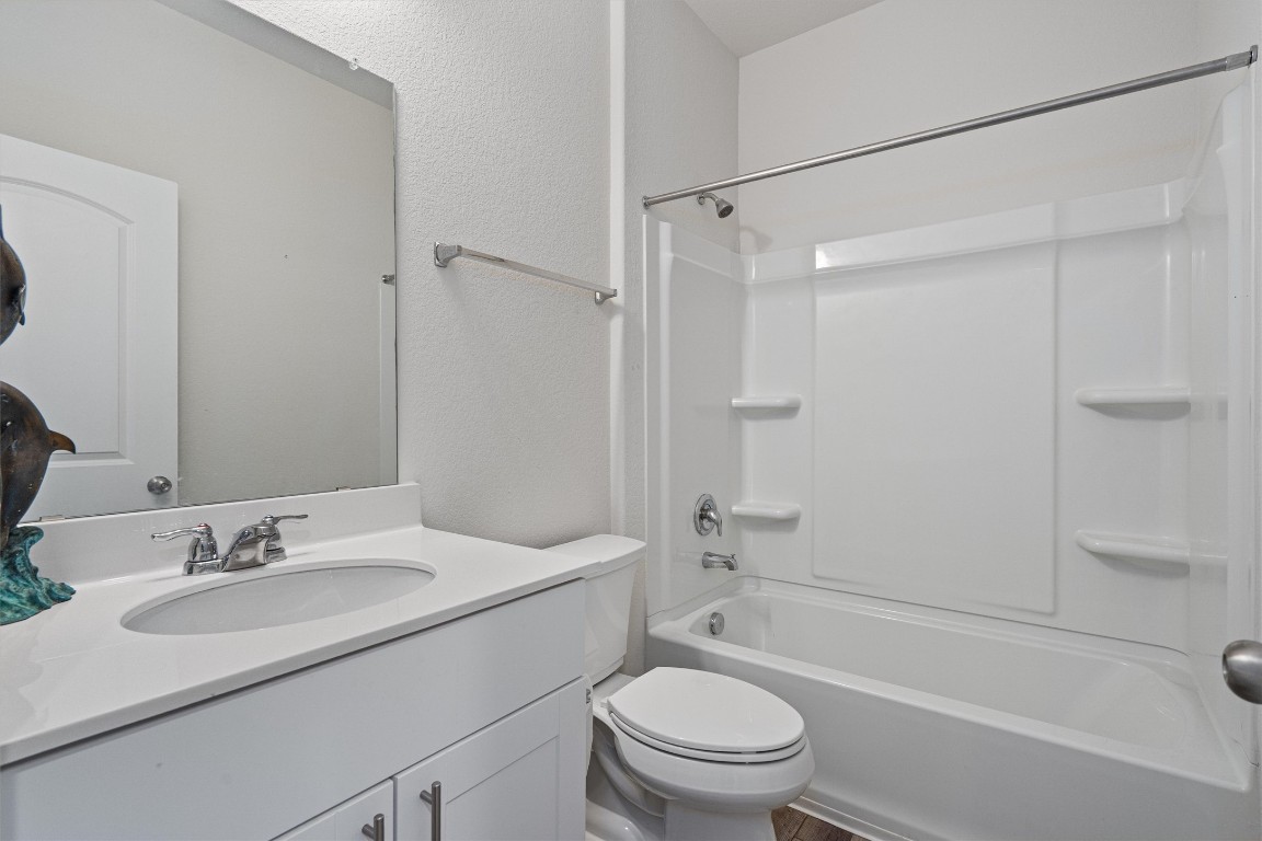 160 Gunther Way Taylor, TX 76574 - Photo 19 of 24 a bathroom with a sink toilet vanity and shower