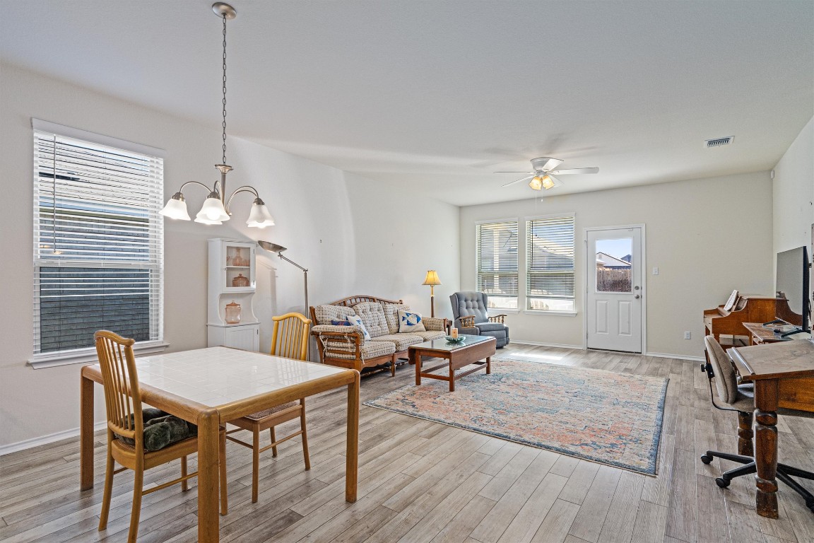 160 Gunther Way Taylor, TX 76574 - Photo 8 of 24 a living room with furniture a window and a chandelier