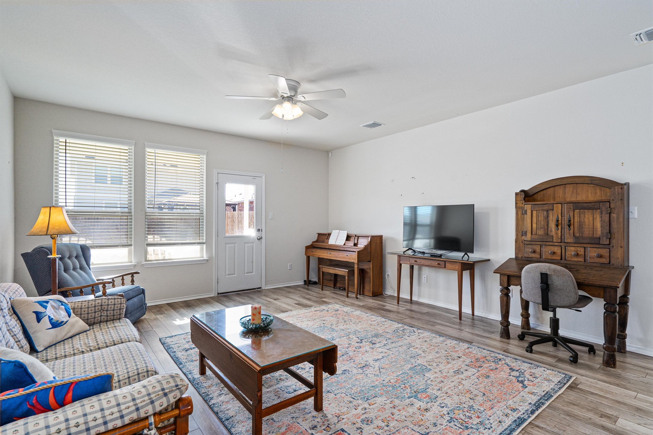 160 Gunther Way Taylor, TX 76574 - Photo 9 of 24 a living room with furniture a flat screen tv and a window
