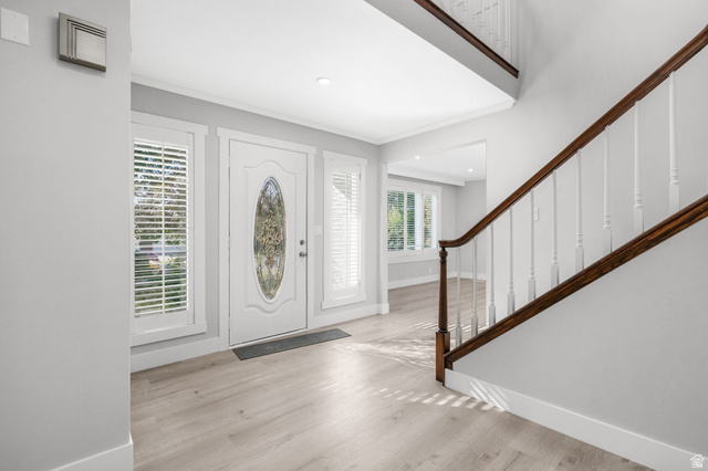 8965 Quail Run Drive Sandy, UT 84093 - Photo 17 of 56 Foyer featuring light wood-style flooring, ornamental molding, and recessed lighting