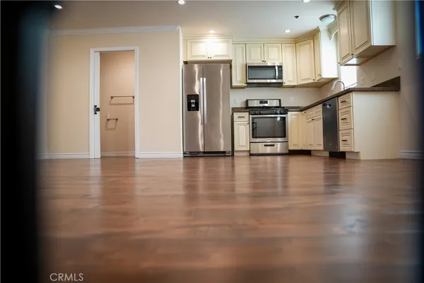 a view of a hallway with wooden floor