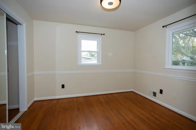 a view of backyard of house with trees