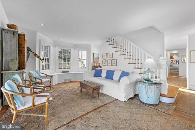 a bedroom with furniture and a large window