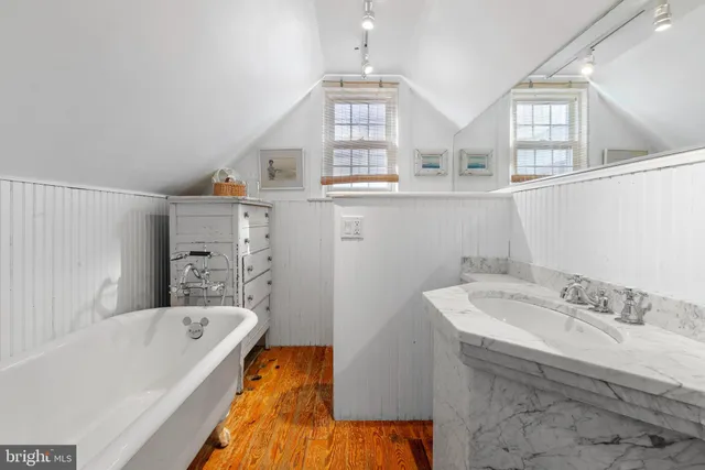 a view of a house with a tree in front of it