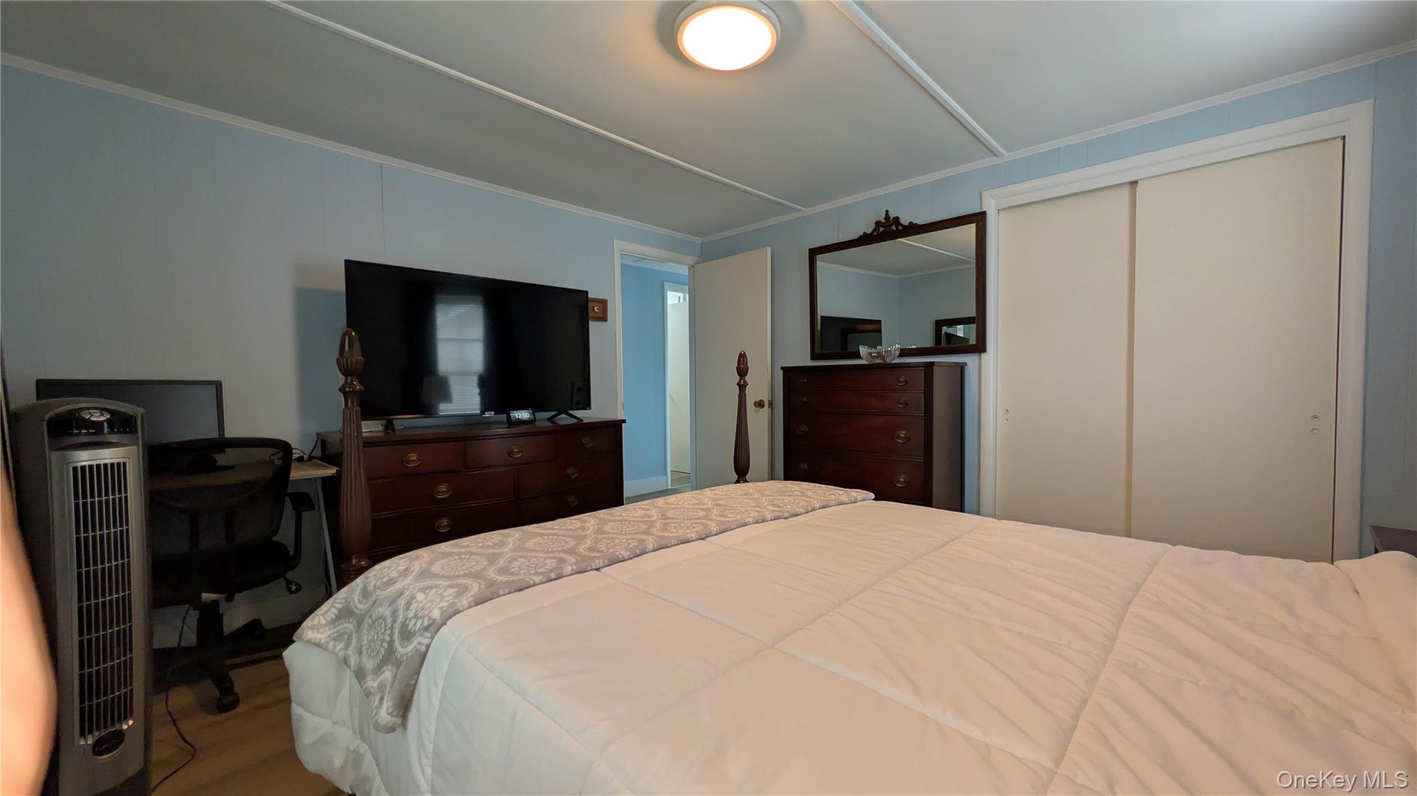 191 Sylvan Lake Road, Unit 28A Hopewell Junction, NY 12533 - Photo 20 of 38 a bedroom with a bed and a flat tv screen on wall