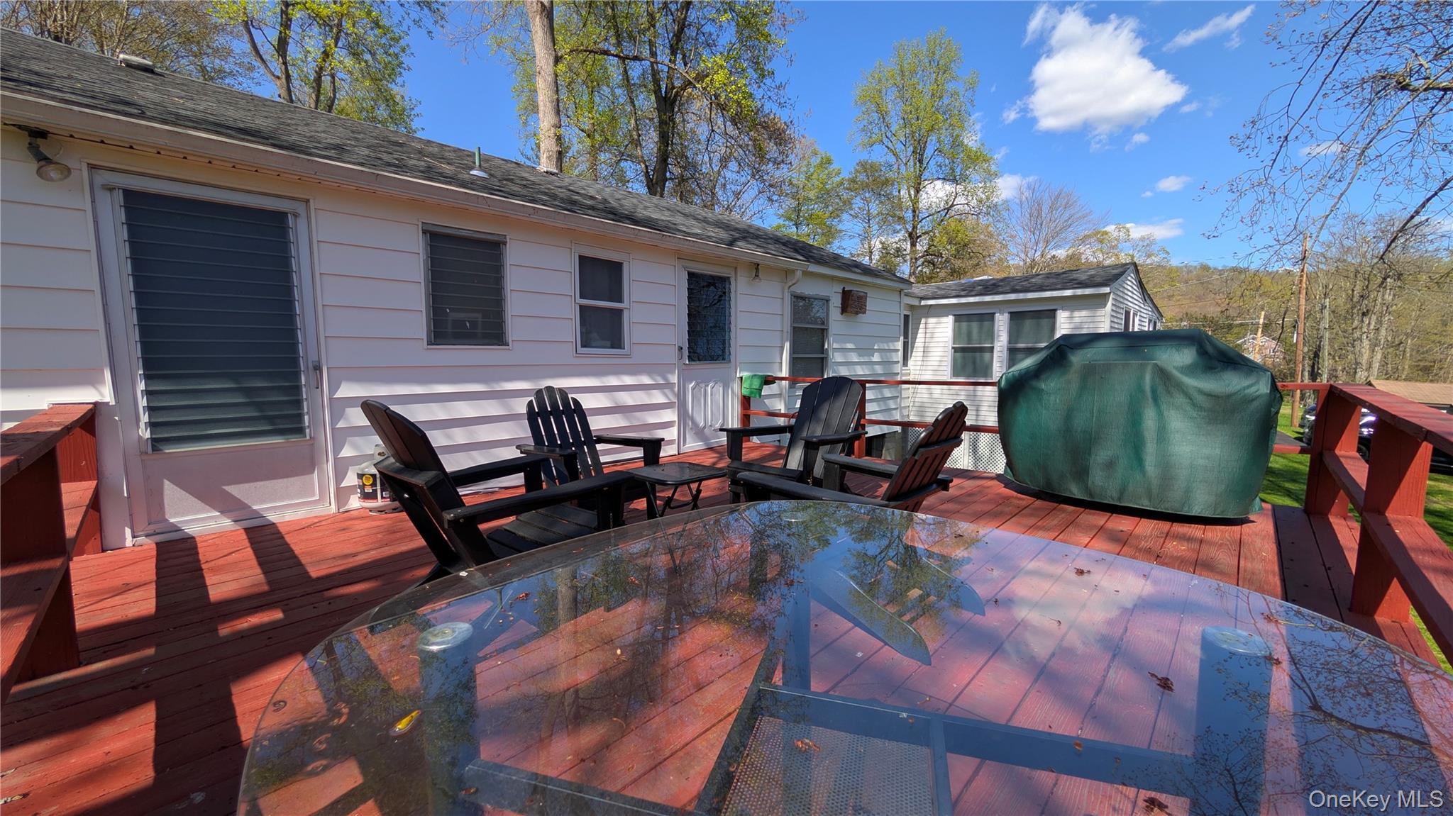 191 Sylvan Lake Road, Unit 28A Hopewell Junction, NY 12533 - Photo 29 of 38 a view of a patio with couches table and chairs with wooden floor