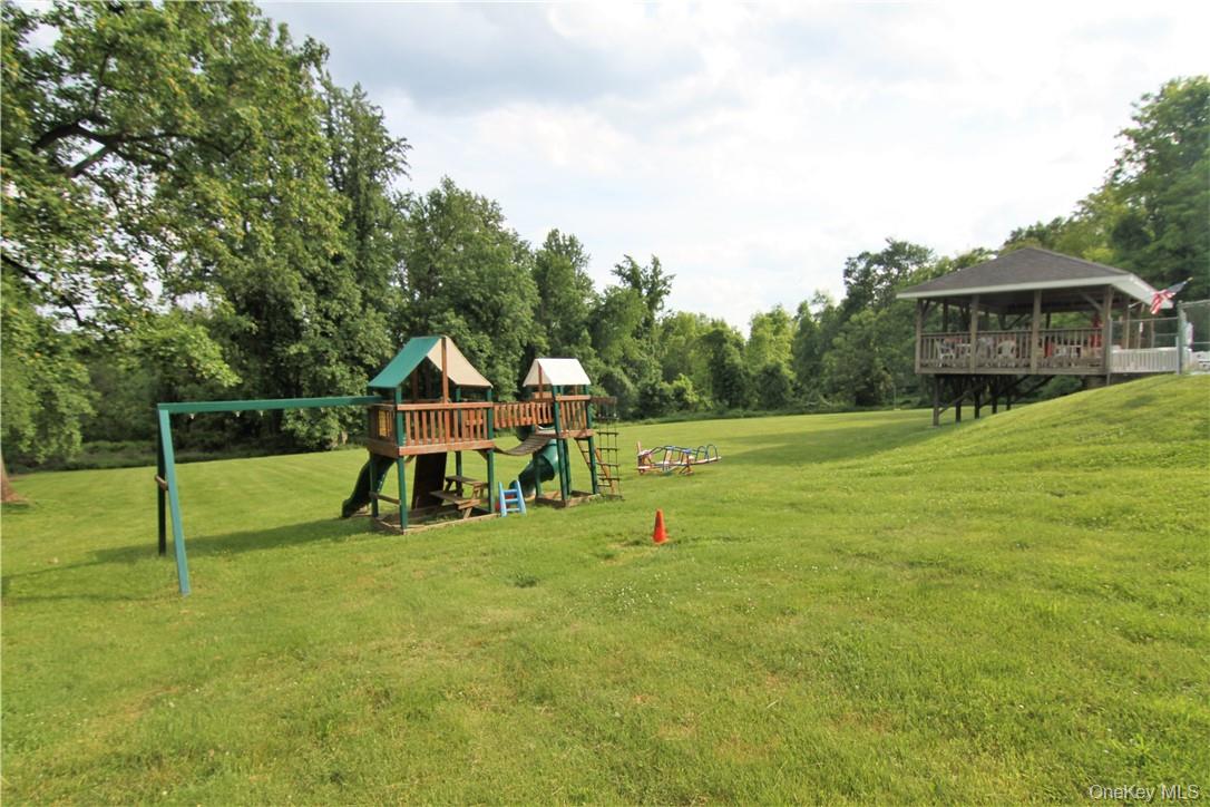 191 Sylvan Lake Road, Unit 28A Hopewell Junction, NY 12533 - Photo 32 of 38 a view of a house with a yard and sitting area