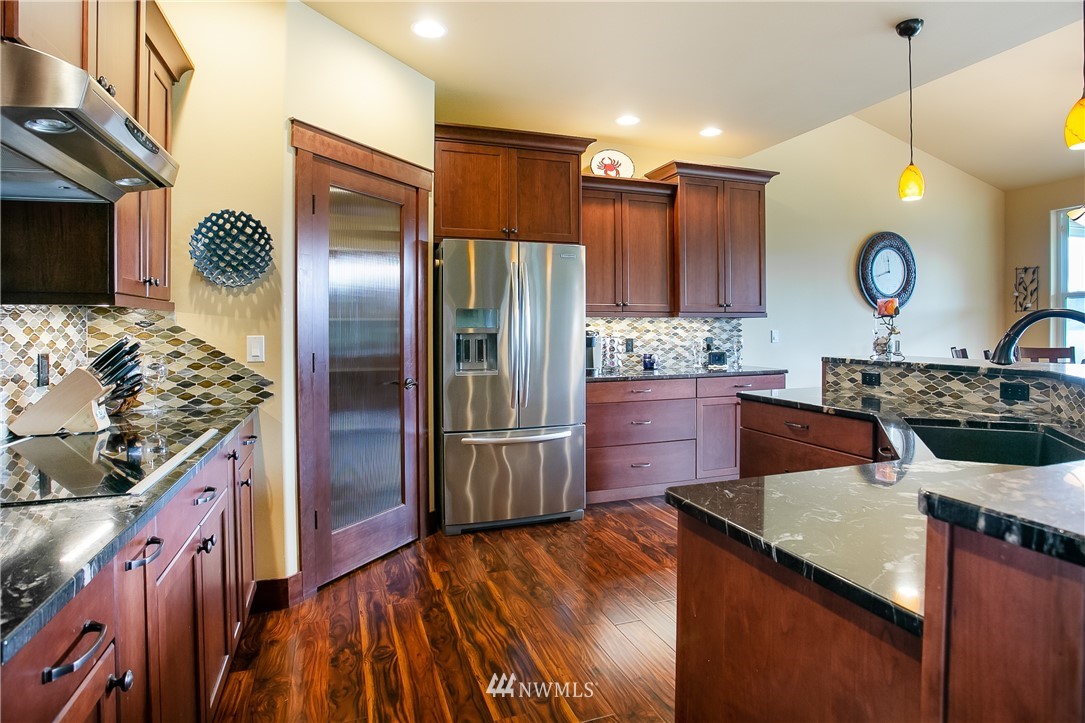 3191 McGee Road Custer, WA 98240 - Photo 5 of 27 a kitchen with stainless steel appliances granite countertop a stove a refrigerator and a wooden cabinets