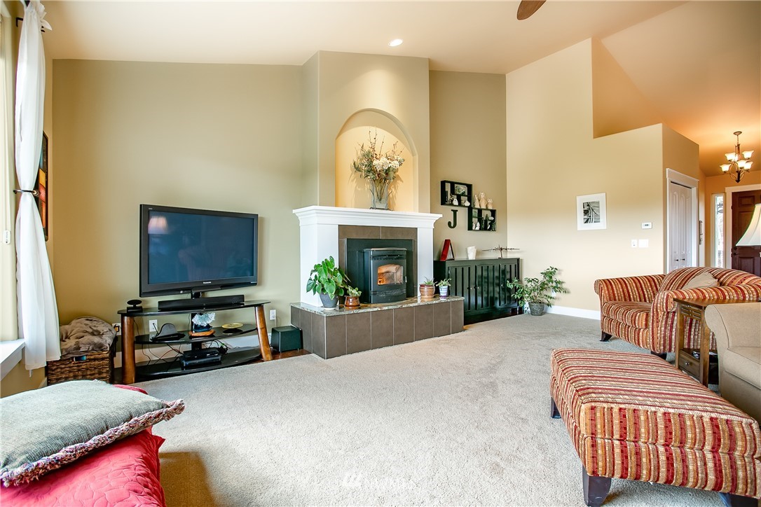 3191 McGee Road Custer, WA 98240 - Photo 8 of 27 a living room with furniture a fireplace and a flat screen tv