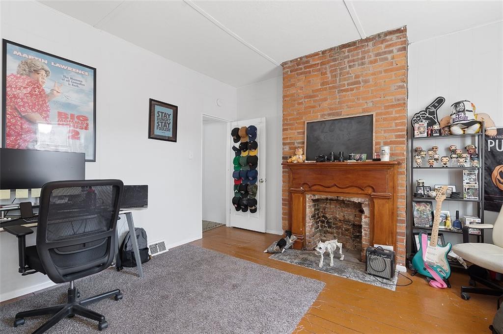 5206 Butler Street Pittsburgh, PA 15201 - Photo 18 of 24 a livingroom with fireplace dining area and a couch