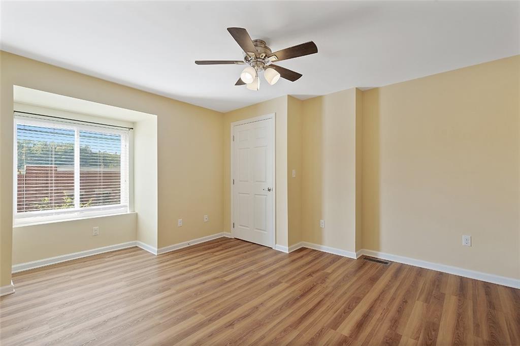 5206 Butler Street Pittsburgh, PA 15201 - Photo 9 of 24 a view of an empty room with wooden floor and a window