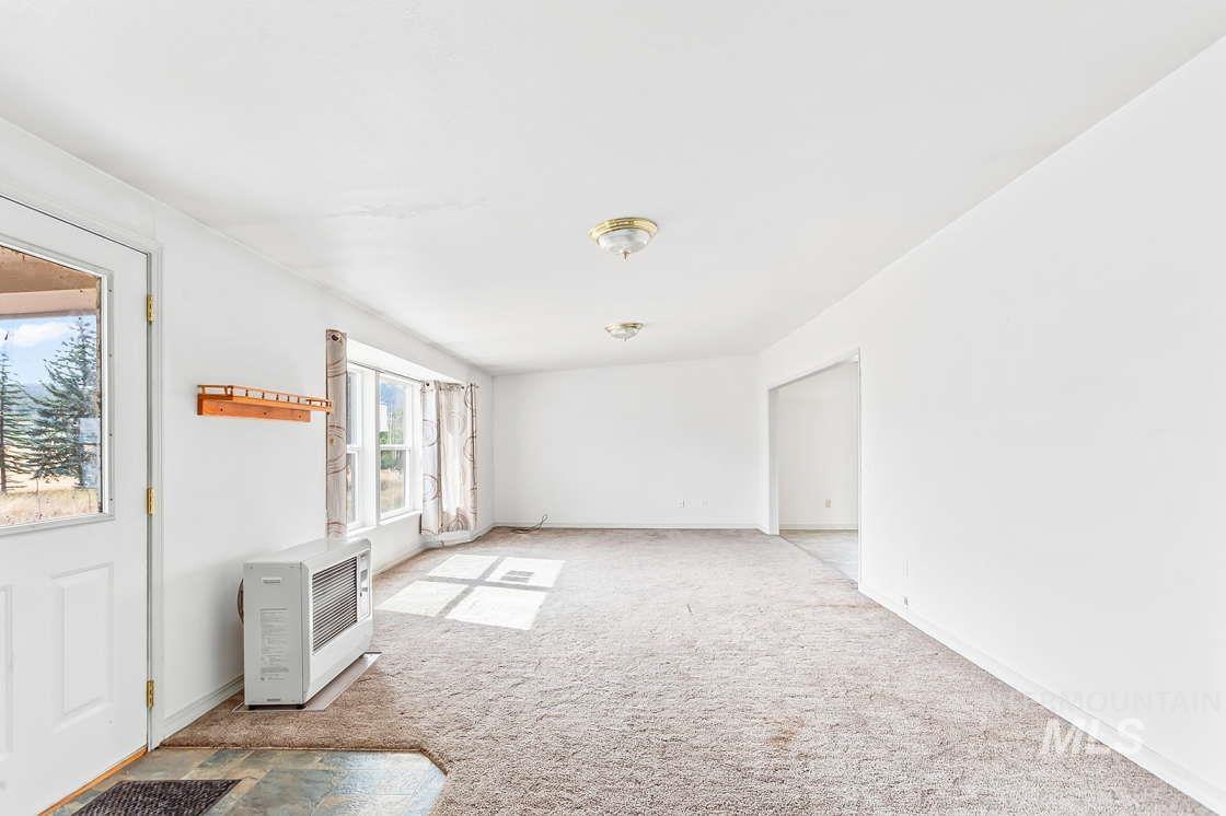255 3 Bear Creek Road Kendrick, ID 83537 - Photo 12 of 44 Unfurnished room with heating unit and carpet floors