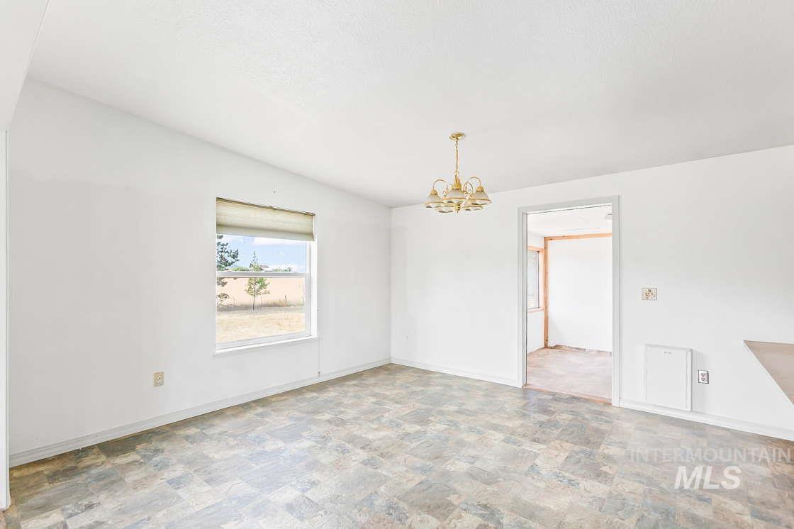 255 3 Bear Creek Road Kendrick, ID 83537 - Photo 15 of 44 Unfurnished dining area with a chandelier and stone finish floors