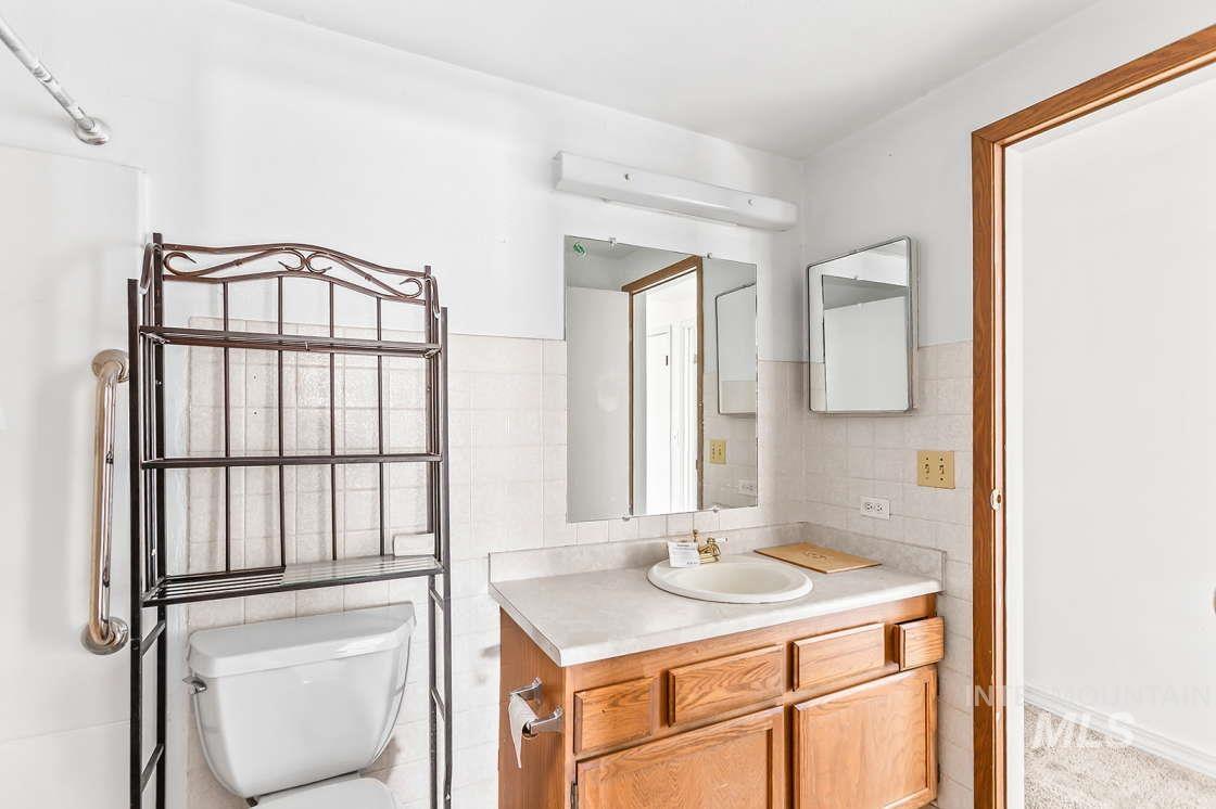255 3 Bear Creek Road Kendrick, ID 83537 - Photo 20 of 44 Bathroom featuring vanity and tile walls
