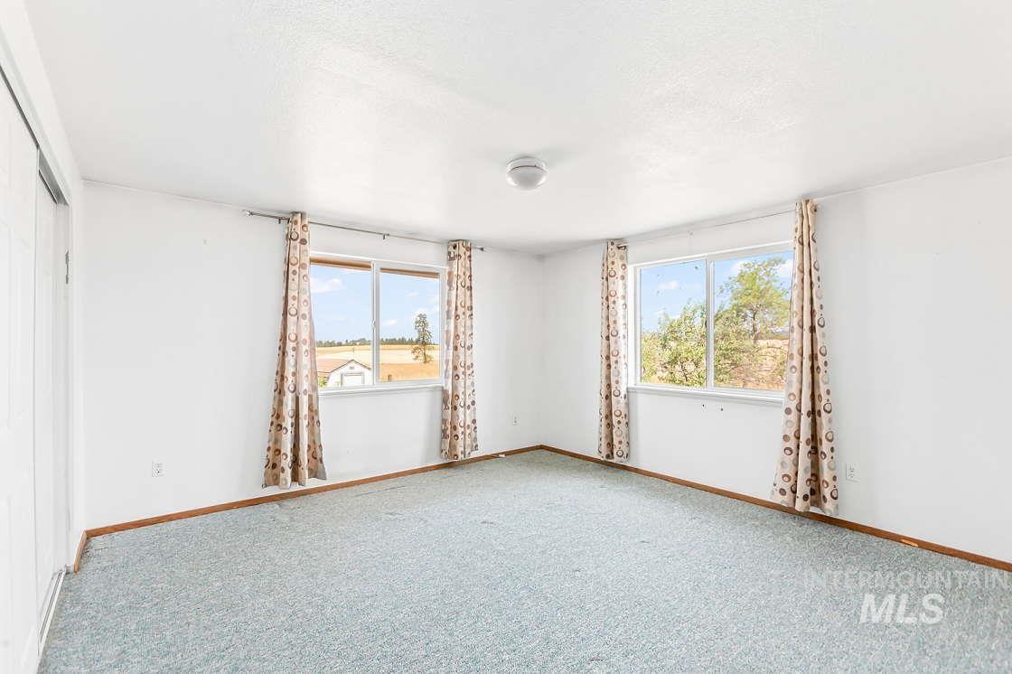 255 3 Bear Creek Road Kendrick, ID 83537 - Photo 26 of 44 Spare room featuring carpet flooring and baseboards