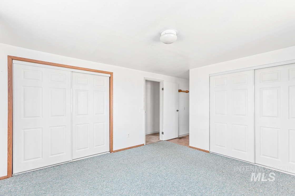 255 3 Bear Creek Road Kendrick, ID 83537 - Photo 27 of 44 Unfurnished bedroom with baseboards and light carpet