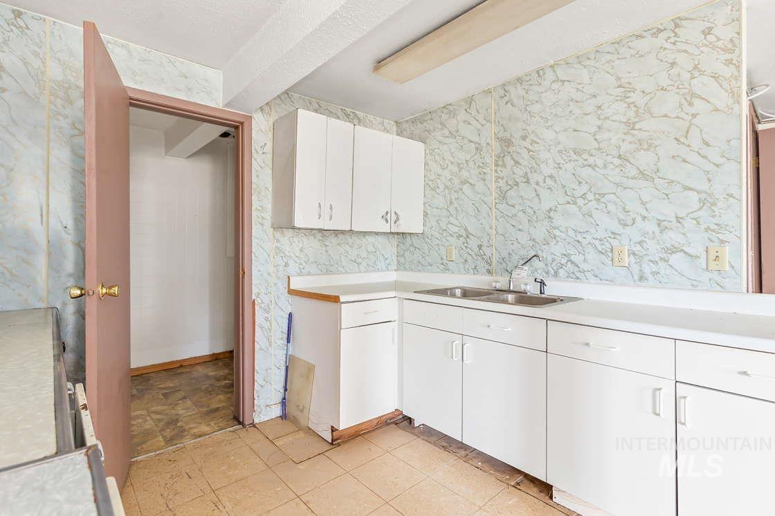 255 3 Bear Creek Road Kendrick, ID 83537 - Photo 34 of 44 Kitchen with light countertops and white cabinets